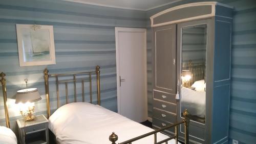 a bedroom with a bed and a dresser with a mirror at Les Vergnes in Saint-Pardoux-le-Neuf
