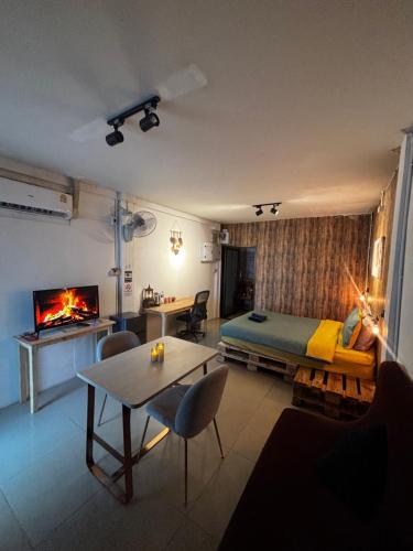 a bedroom with a bed and a living room with a fireplace at La Locanda in Bangkok