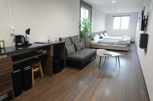 a living room with a couch and a table at RJ HOTELS OTARU in Otaru