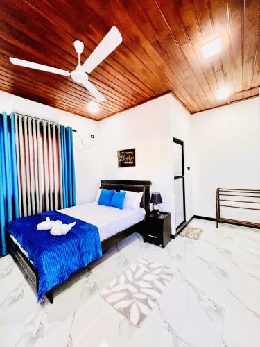 a bedroom with a bed and a wooden ceiling at Rehan Sunset Villa in Negombo