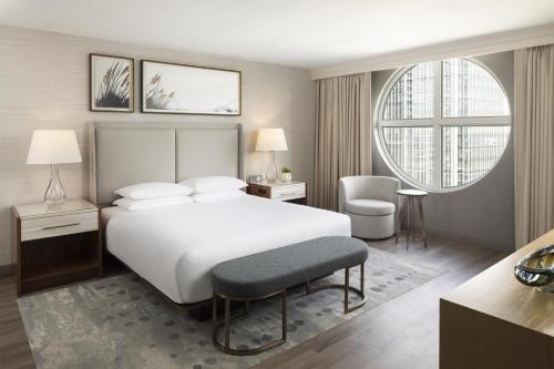 a bedroom with a white bed and a large window at Grand Hyatt Atlanta in Buckhead in Atlanta