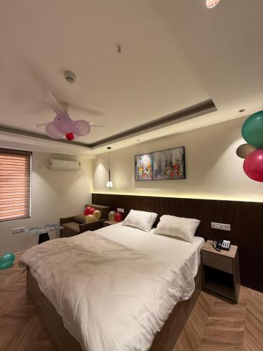 a bedroom with a large bed and balloons on the wall at Cozy haven in Greater Noida