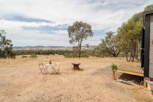 a table and chairs in the middle of a field at Hill View at Euroa by Tiny Away in Euroa