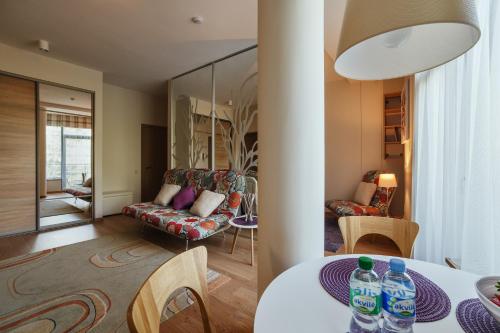 a living room with a table with water bottles on it at Granus apartments in Druskininkai