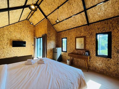 a bedroom with a large bed in a room at Tavana Residence in Ban Na Bon