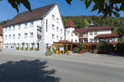 a large white building on the side of a street at Hotel Gasthof Sonne in Fridingen an der Donau