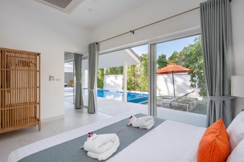 a bedroom with two towel animals on a bed at Bougain Villas in Salad Beach