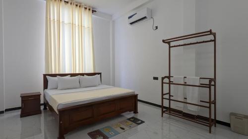 a bedroom with a bed and a metal bed frame at Breeze house in Tangalle