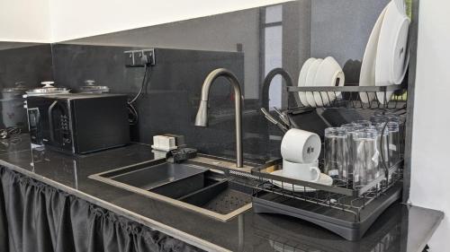 a kitchen with a sink and a counter top at Breeze house in Tangalle