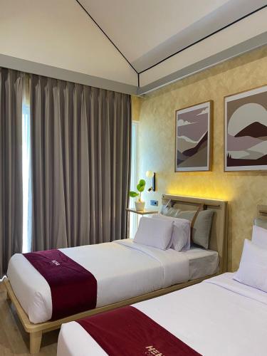 a hotel room with two beds and a window at HeHa Ocean Glamping dan Cabin in Ngundel