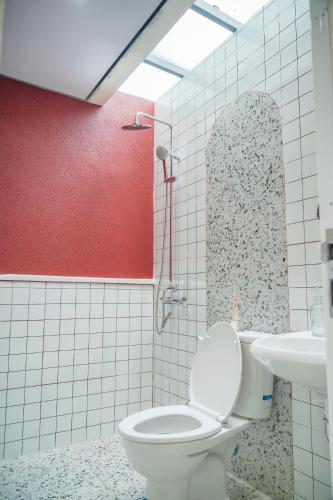 a bathroom with a toilet and a sink at HeHa Ocean Glamping dan Cabin in Ngundel