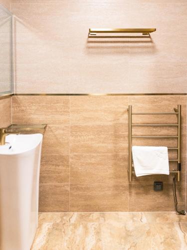 a bathroom with a sink and a towel rack at Błażejewko Resort in Błażejewko