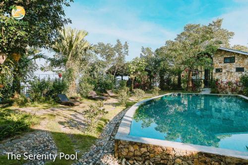 a swimming pool in the yard of a house at TV Palm Ecolodge Ha Giang in Ha Giang
