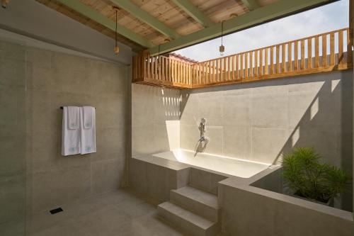 a staircase in a room with a window and a statue at Stay Ceylon - Weligama in Weligama