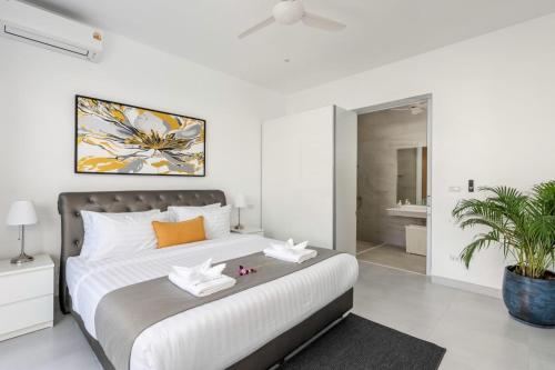 a bedroom with a large bed and a bathroom at Buddha Bliss Luxury Villa in Ban Madua Wan