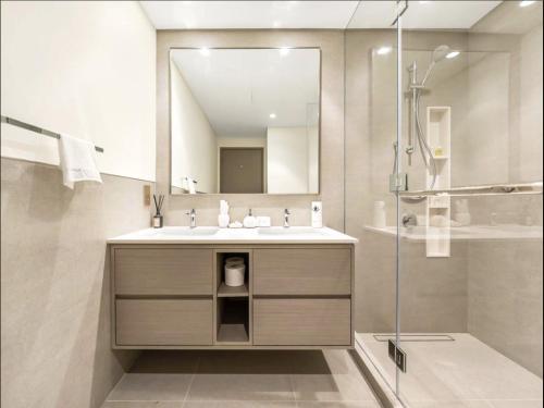 a bathroom with a sink and a mirror at Private Room in Downtown Burj Vista Apartment with Burj Khalifa View in Dubai