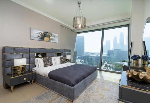 a bedroom with a large bed and a large window at Private Room in Downtown Burj Vista Apartment with Burj Khalifa View in Dubai
