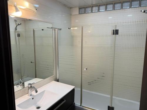 a bathroom with a glass shower and a sink at Har nof rooftop in Jerusalem