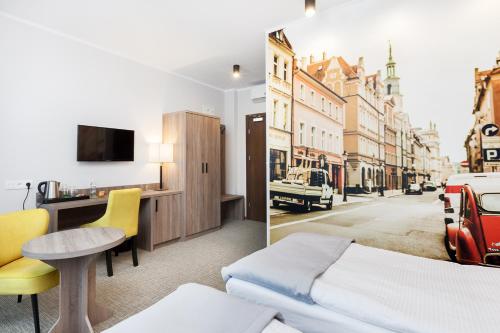 a hotel room with a bed and a view of a street at Meet Poznań Hotel in Poznań