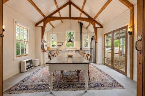 a kitchen with a table and chairs in a room at Amara Creek Retreat in Margaret River Town