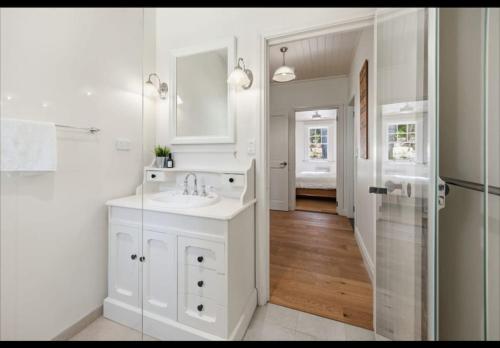 a white bathroom with a sink and a shower at Amara Creek Retreat in Margaret River Town