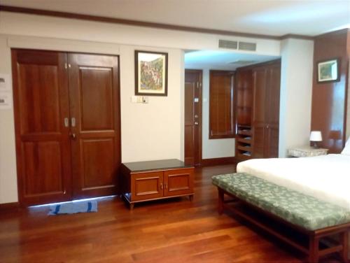 a bedroom with a bed and a wooden floor at GLX Private Pool Villa in Port Dickson