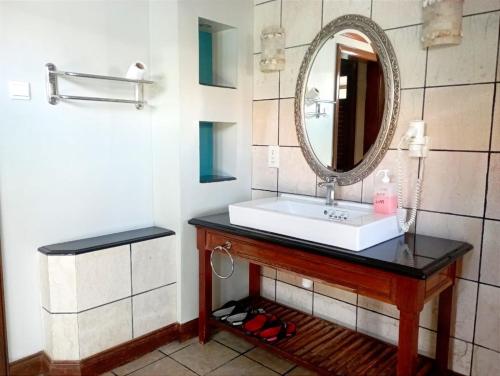 a bathroom with a sink and a mirror at GLX Private Pool Villa in Port Dickson
