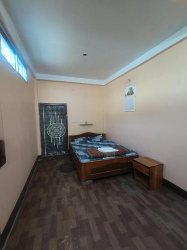 a small room with a bed in the corner at Abhishek Homestay in Dum Duma
