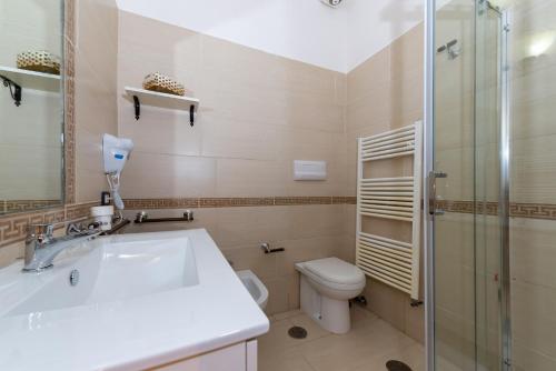 a bathroom with a sink and a toilet and a shower at Martina B&B in Agropoli