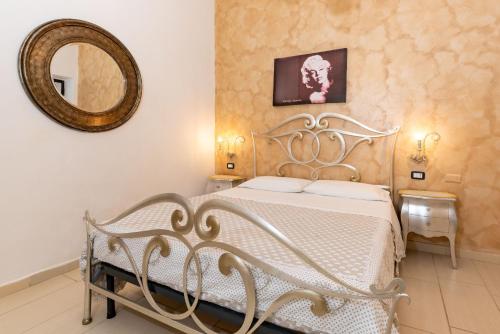 a bedroom with a white bed and a mirror at Martina B&B in Agropoli