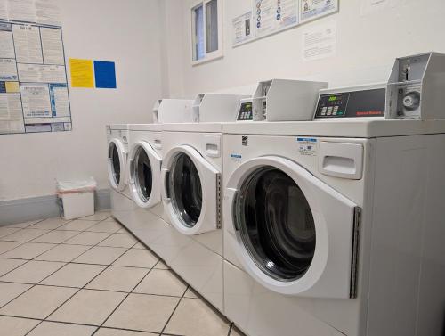 two washing machines sitting in a laundry room at Winsor Hotel in San Francisco