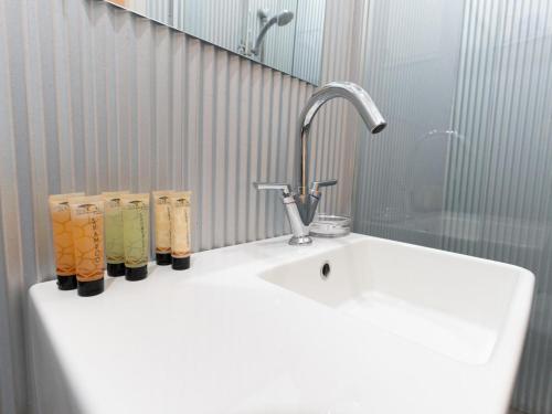 a sink with a faucet and three cups on it at Imperial Homestead in York