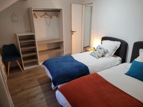 a small room with two beds and a closet at Le Moulin des Puys in Orcines
