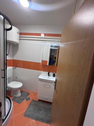 a bathroom with a toilet and a sink at Apartment Story in Pale