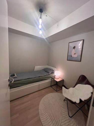 a bedroom with a bed and a table and a chair at Cozy private room centrally in Jessheim in Jessheim