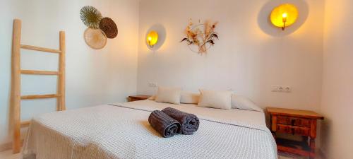 a bedroom with a bed with two pillows on it at VelenaRubia in Vélez-Málaga