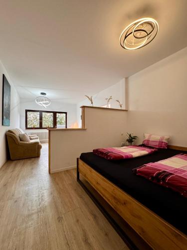 a bedroom with a bed and a couch in it at Appartment in Freizeitpark in Wiesloch