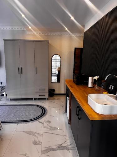 a large bathroom with a sink and a counter at The Rooms Lara in Antalya