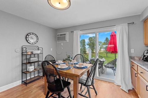 a kitchen and dining room with a table and chairs at Beachside Condo w Stunning Lake Views in Sheboygan