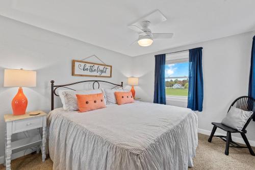 a bedroom with a bed and a chair and a window at Beachside Condo w Stunning Lake Views in Sheboygan