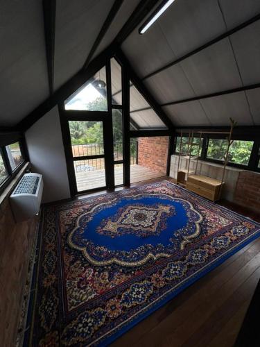 a large rug on the floor in a room at Tiny House in Kuala Terengganu