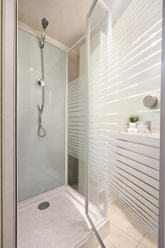 a shower with a glass door in a bathroom at Le Nid Comtois in Vic-le-Comte