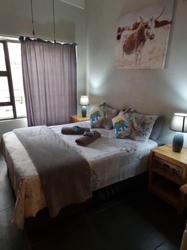 a bedroom with a bed with pillows on it at Geckos Rest Southbroom in Southbroom