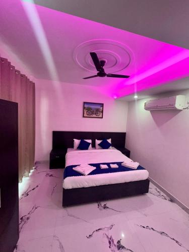 a bedroom with a bed with a purple ceiling at Cabana suites in Rishīkesh