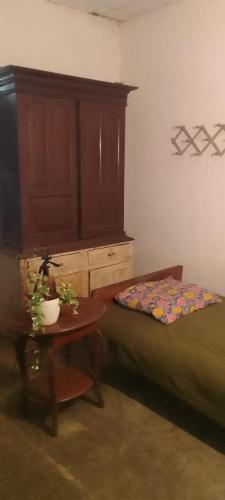 a bedroom with a bed and a table and a cupboard at Lakeview since 1963 in Pilawala