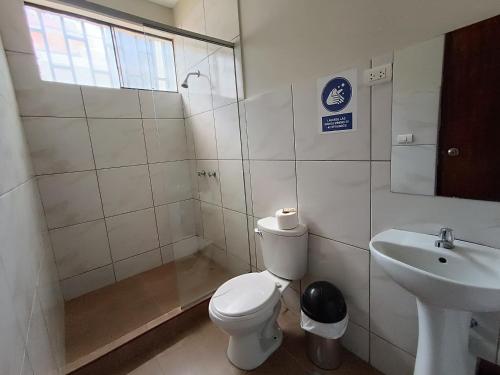 a bathroom with a toilet and a sink at Villa Gabriel Hotel in Piura
