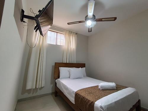 a bedroom with a bed and a ceiling fan at Villa Gabriel Hotel in Piura