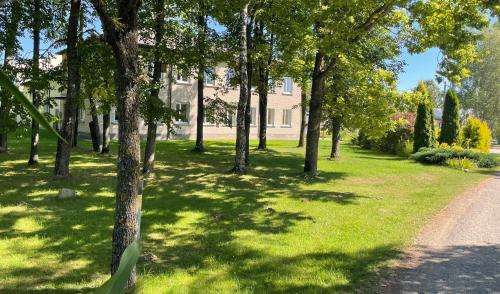 un parco con alberi e una strada sterrata di Nichi camp a Dekšāre