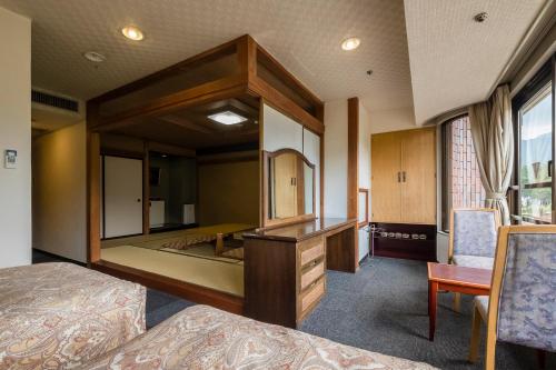 a bedroom with a large mirror and a desk at Shiki-no-Yado Fujisan in Fujikawaguchiko