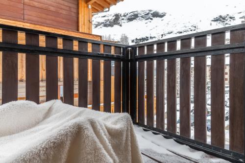 a deck with a fence with snow on it at HelloCHALET - Front Row with balcony overlooking the Cretaz slopes in Breuil-Cervinia